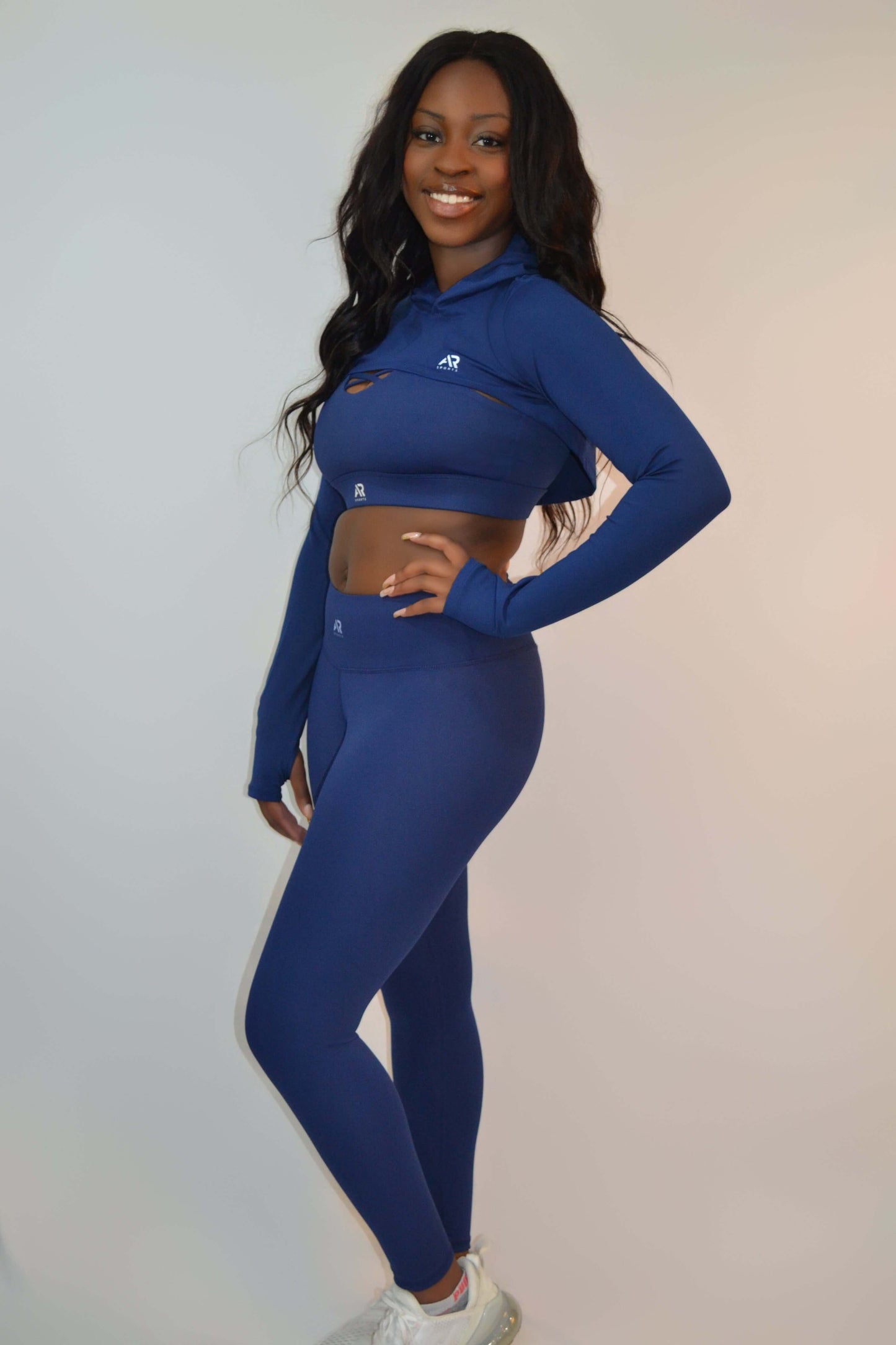 Women in a blue long sleeve top and leggings from the Women's 3pcs Seli Yoga Leggings Set, perfect for yoga.
