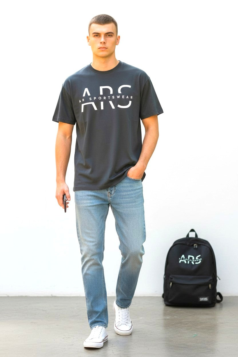 Men's Classic ARS Logo T-Shirt worn by a man with jeans and a backpack in a casual setting.