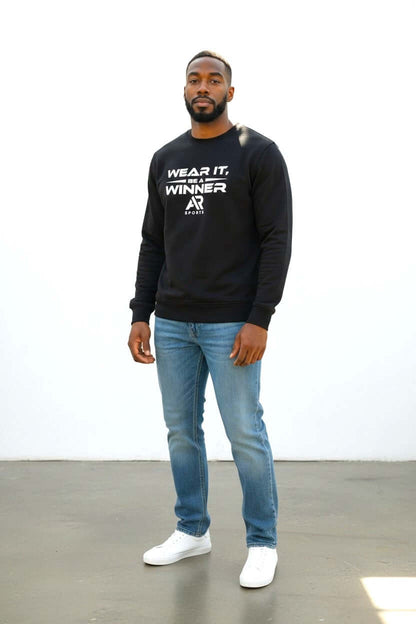 Man wearing a round neck sweater and jeans, showcasing a stylish and comfortable look.