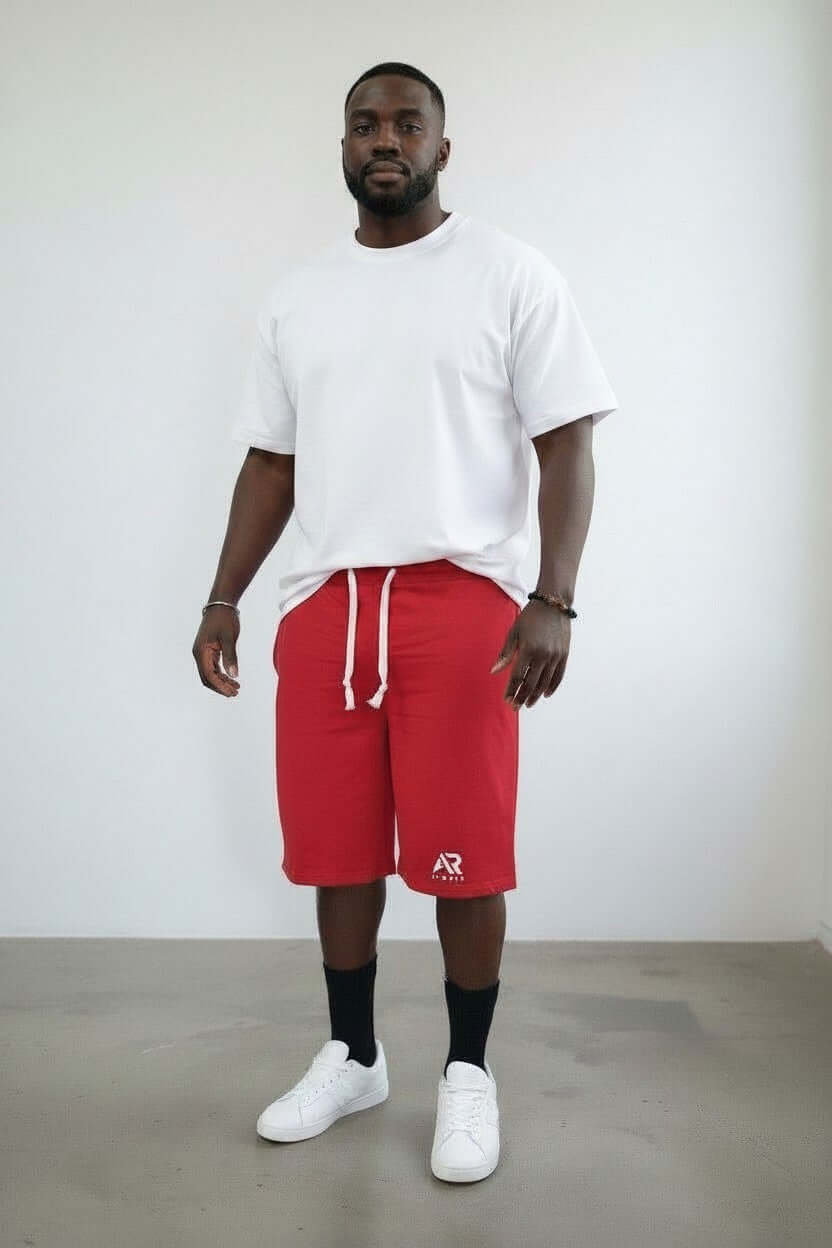 Men's French Terry Fabric shorts in red worn by a man with a white t-shirt and sneakers.