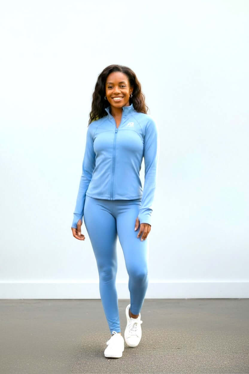 women in a light blue full zip tracksuit, perfect for activewear and comfortable lounging.