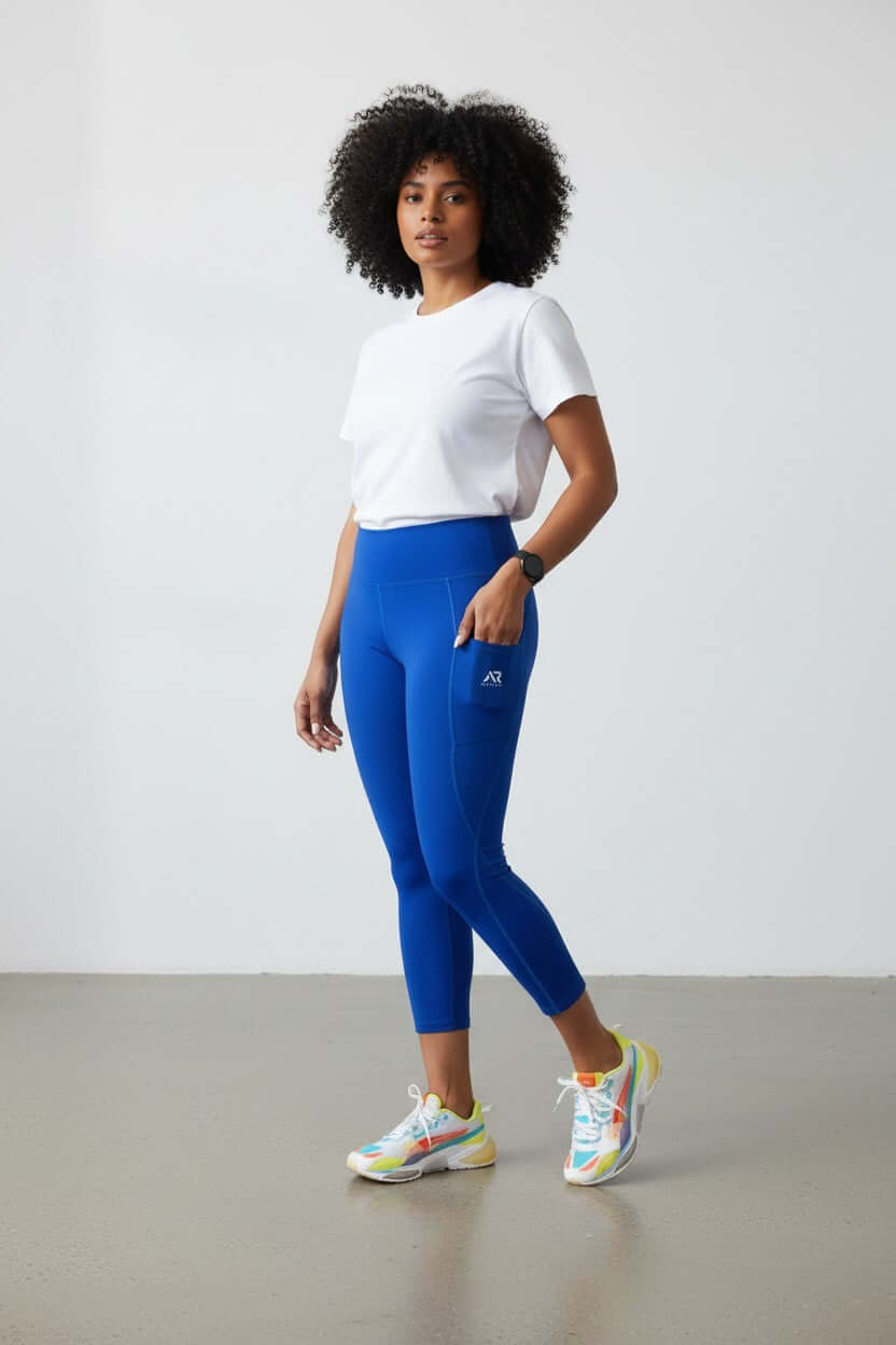 Women wearing blue high waist leggings with side pockets and a white tee, showcasing style and comfort.