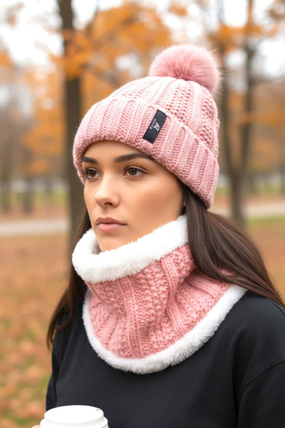 Women wearing a pink winter Kiki beanie and neck warmer, enjoying coffee in autumn park.