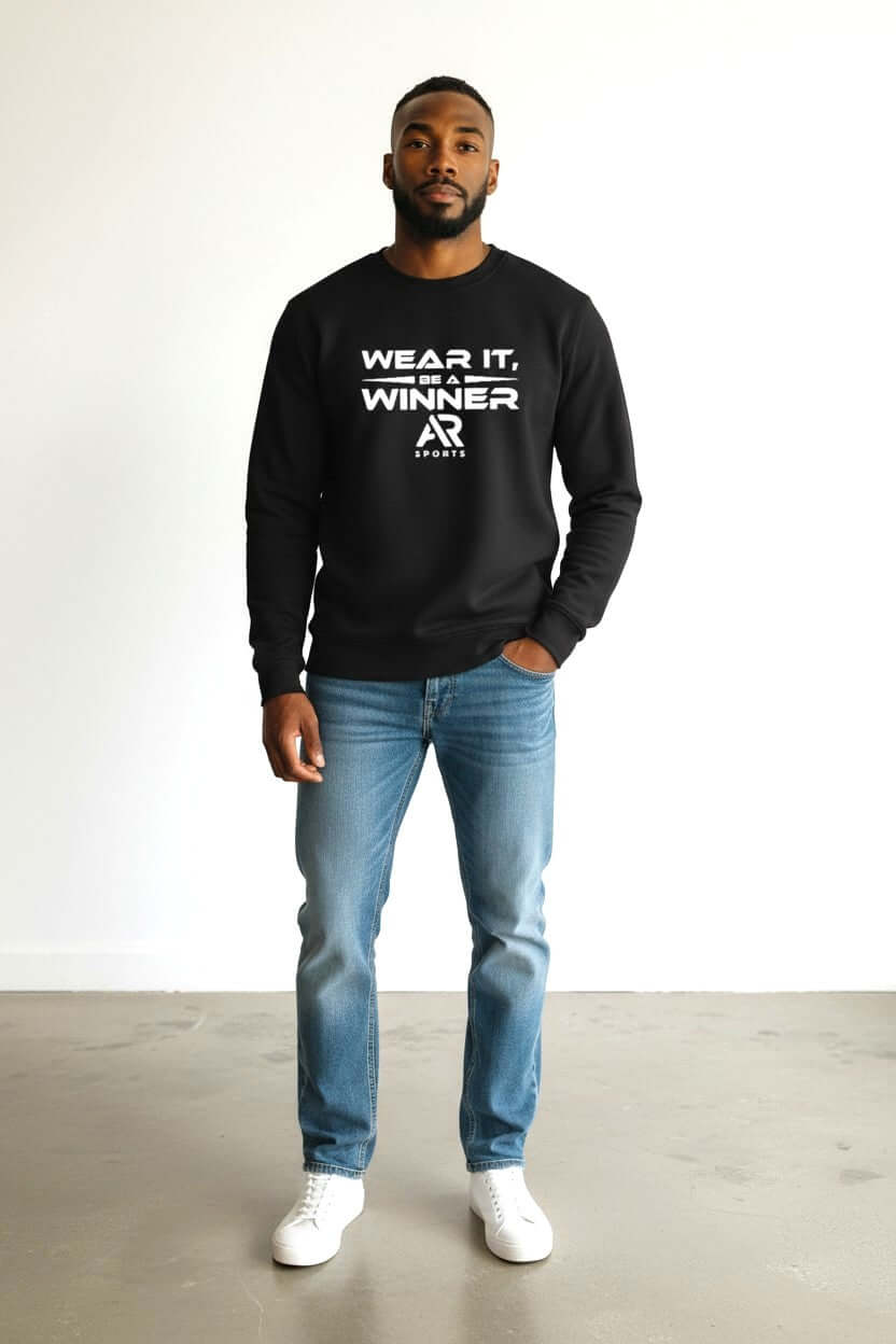 Model wearing a round neck sweater with 'WEAR IT, WINNER' text, paired with jeans and sneakers.