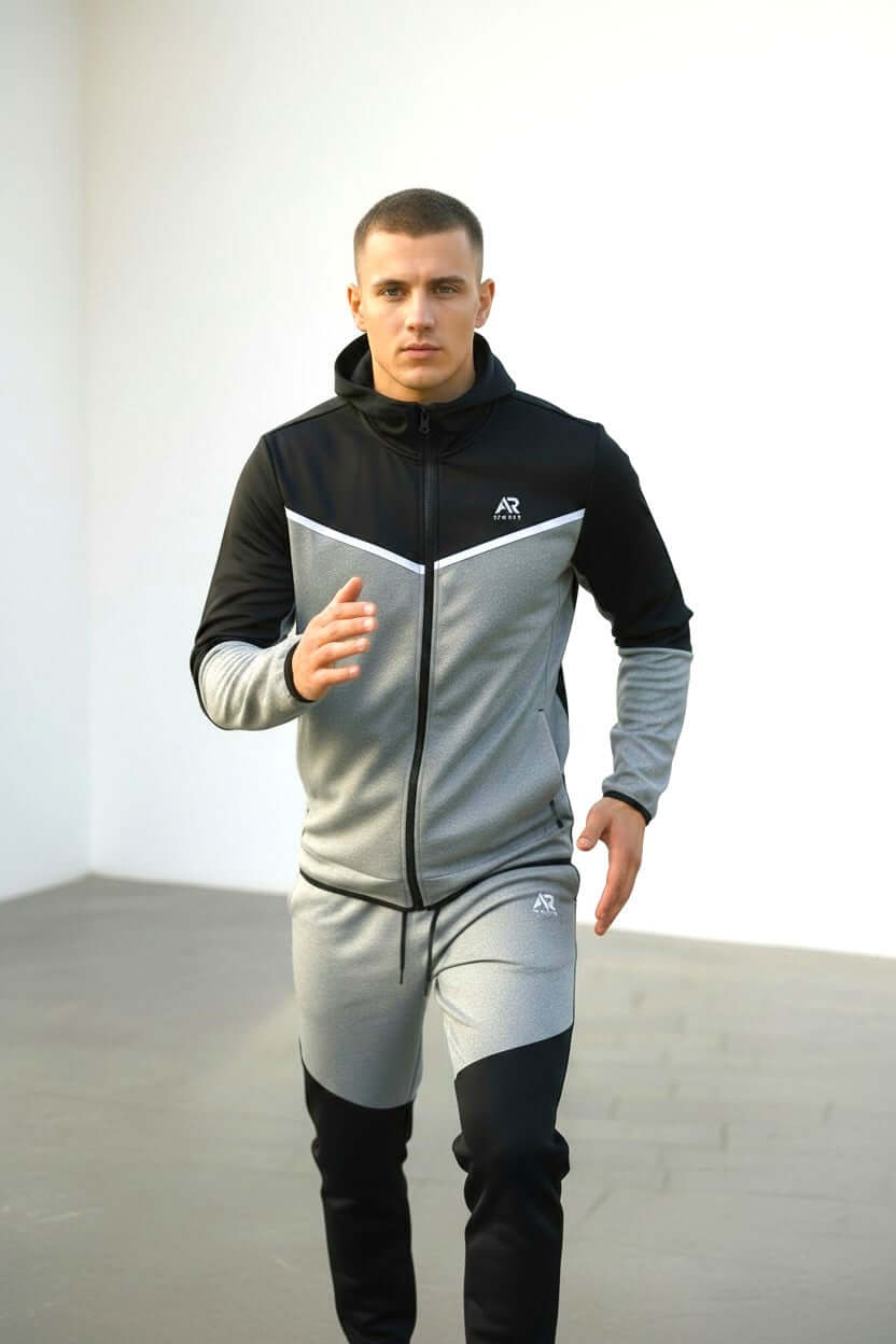 Men wearing AR Sportswear 2Pcs Hoodie Tracksuit while jogging indoors, showcasing style and comfort.