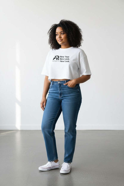 Model wearing a women's oversize crop top t-shirt with high-waisted jeans, showcasing comfort and style.