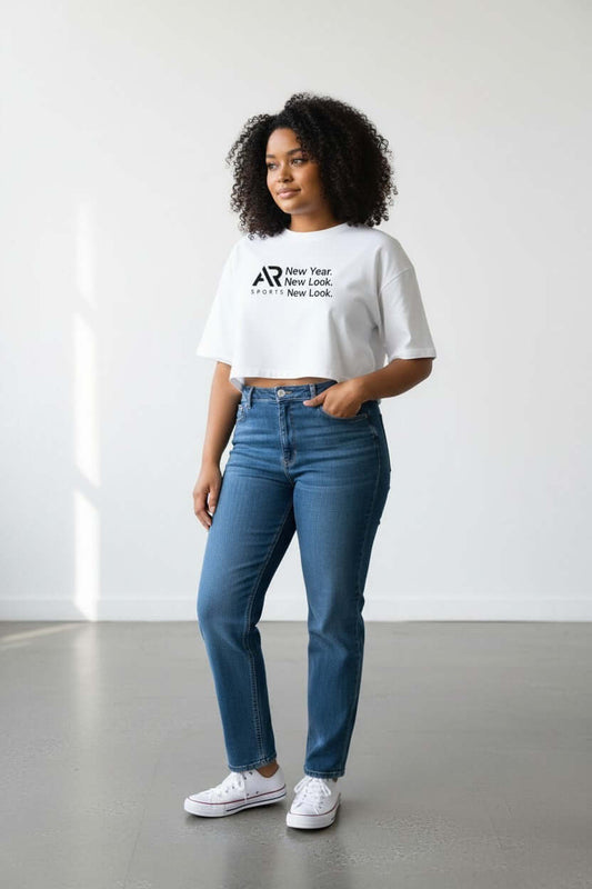Model wearing a women's oversize crop top t-shirt with high-waisted jeans, showcasing comfort and style.