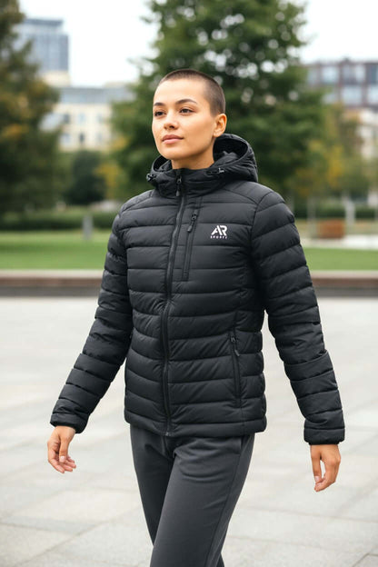 Man wearing a stylish black men's winter down puffy jacket with detached hood during a city stroll.