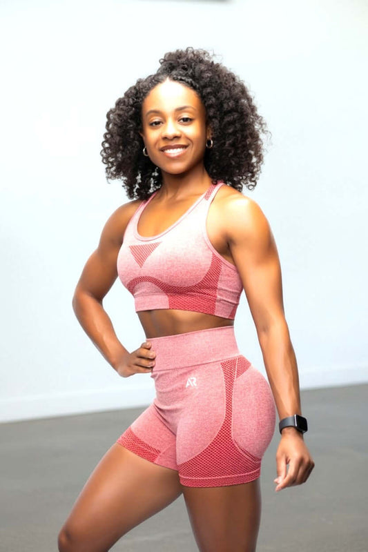 women's sleeveless gym booty shorts & bra set worn by a fit model in a bright gym setting
